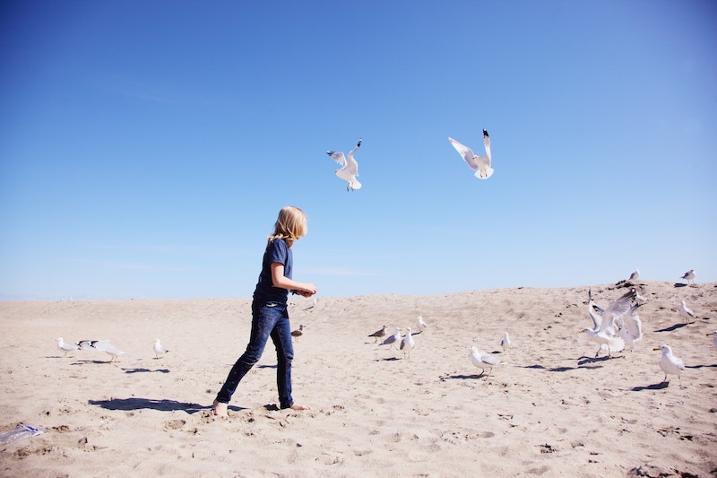A child plays in the dunes at Hampton Beach